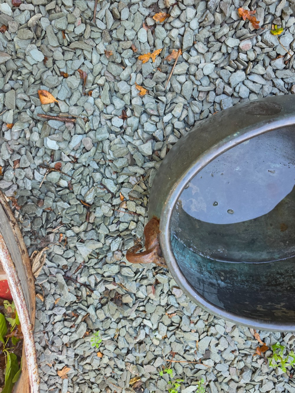 A large 19th-century copper cauldron with a rounded body, rolled rim, iron handles, and a verdigris patina. View IV