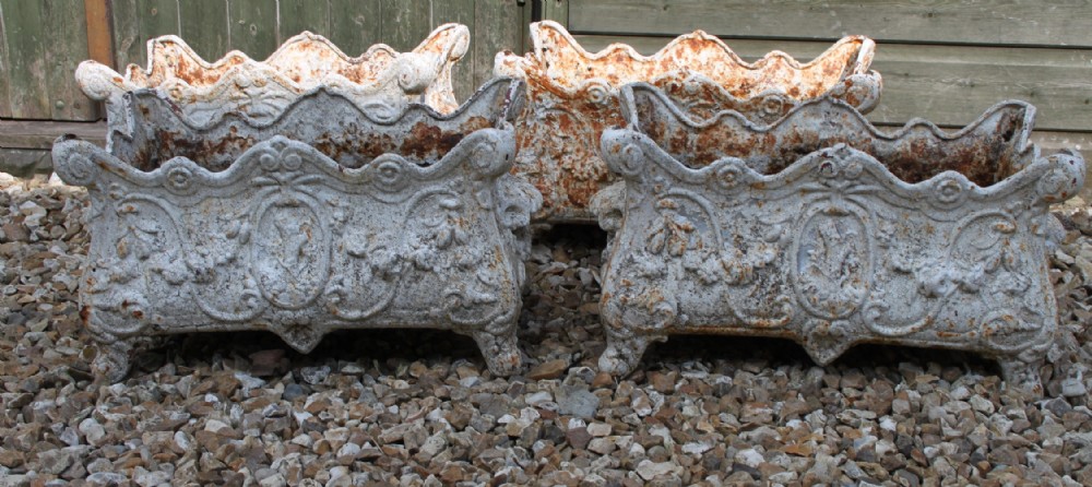 FOUR CAST IRON PLANTERS

