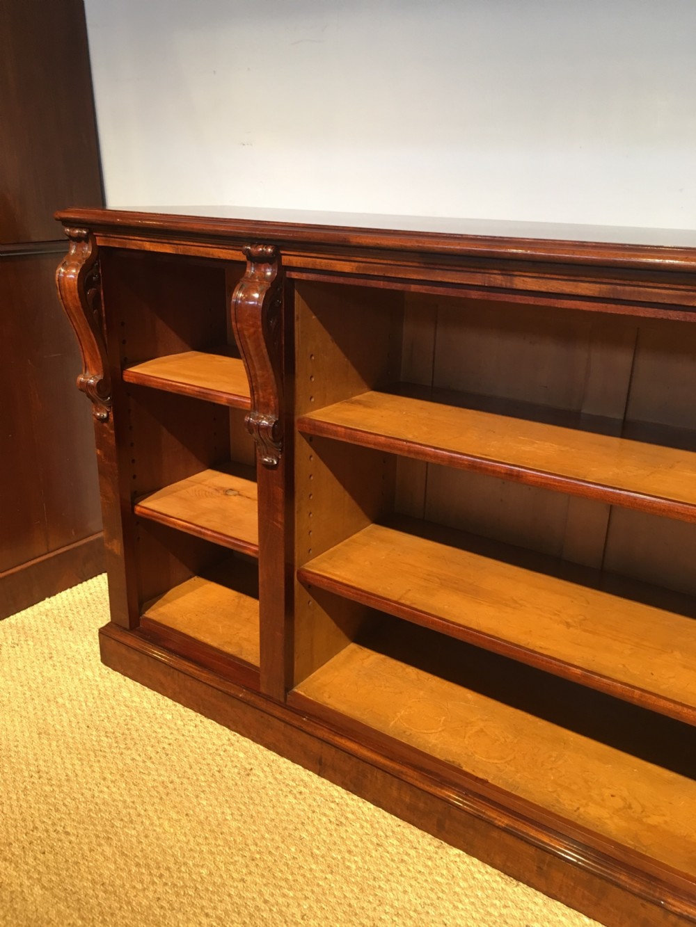 Long low mahogany bookcase  View II