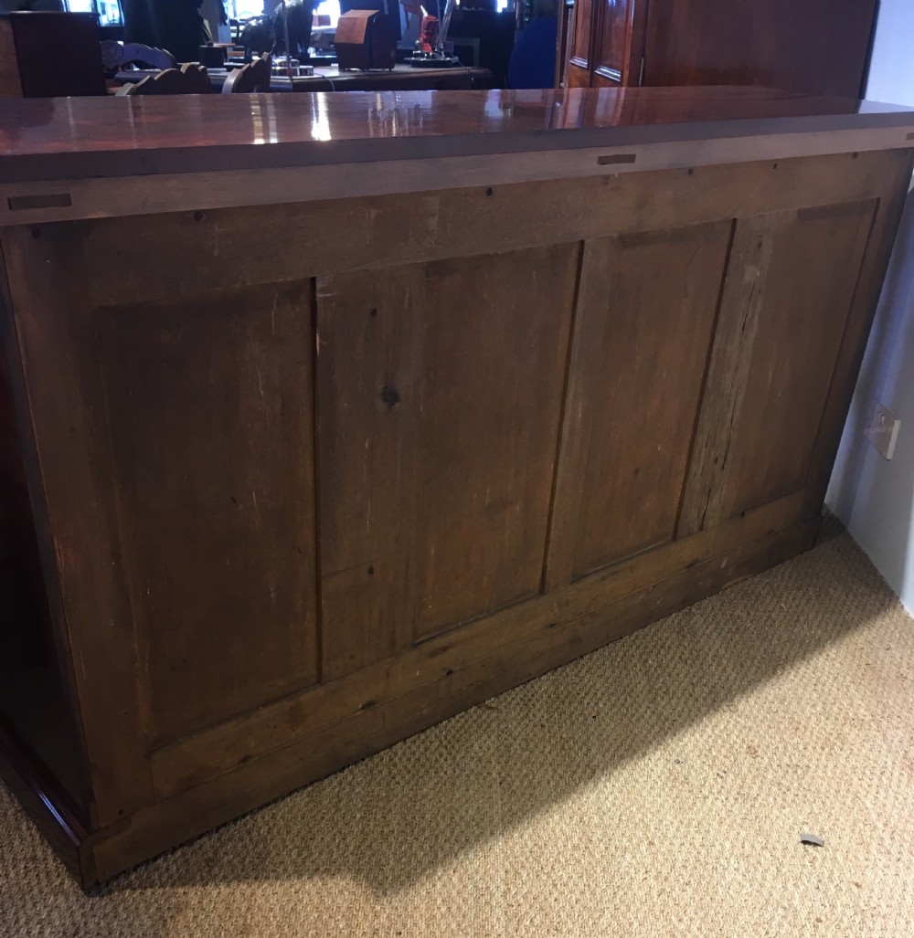 Long low mahogany bookcase  View XI