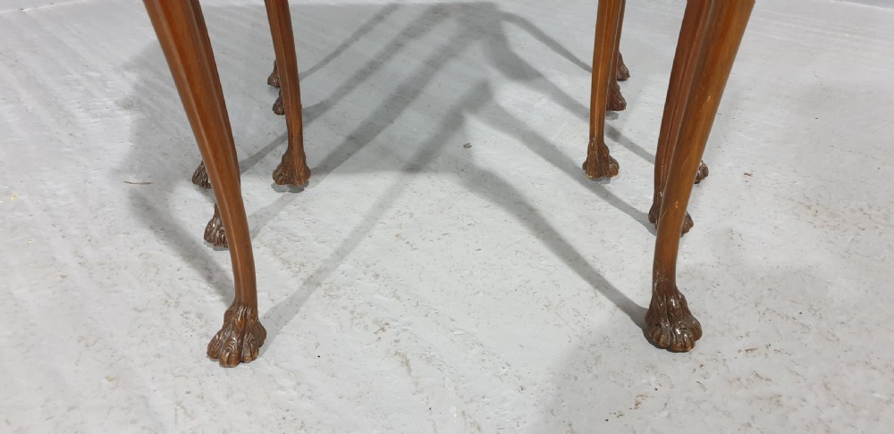 A set of three graduated burr walnut nesting tables with carved borders, cabriole legs, and claw and ball feet. View II
