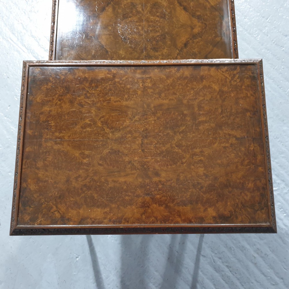 A set of three graduated burr walnut nesting tables with carved borders, cabriole legs, and claw and ball feet. View V