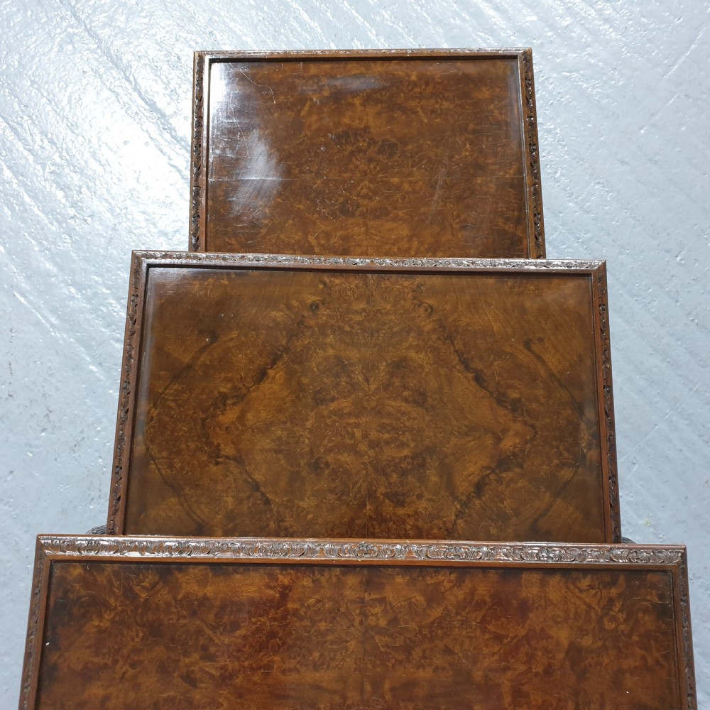 A set of three graduated burr walnut nesting tables with carved borders, cabriole legs, and claw and ball feet. View VI