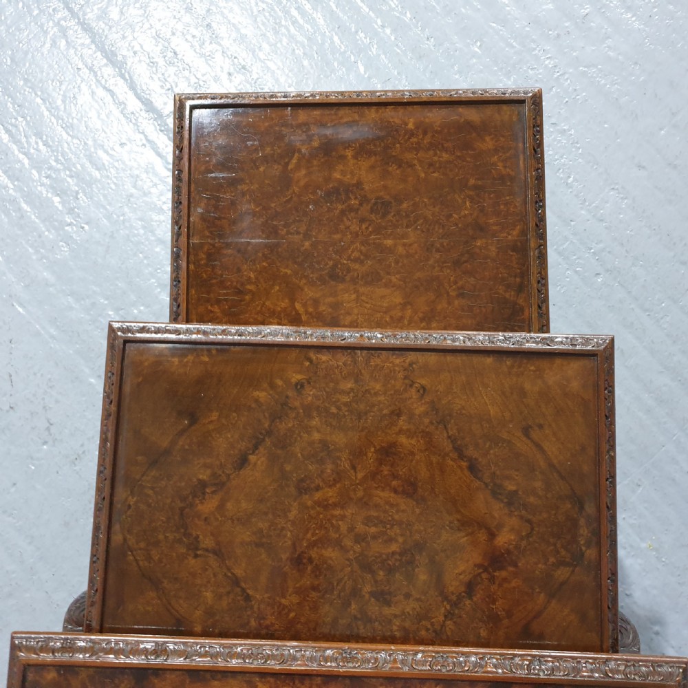 A set of three graduated burr walnut nesting tables with carved borders, cabriole legs, and claw and ball feet. View VII