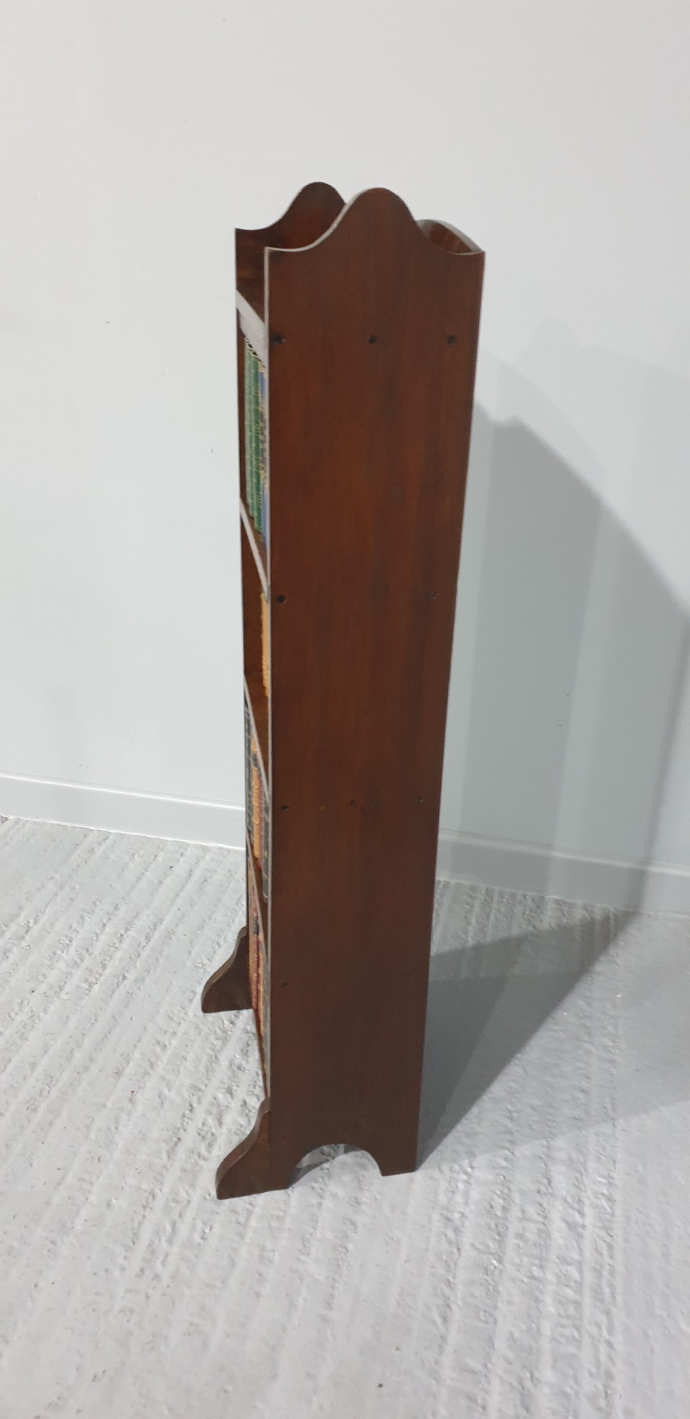 A tall, narrow open oak bookcase featuring four fixed shelves and shaped side panels standing on bracket feet. View III