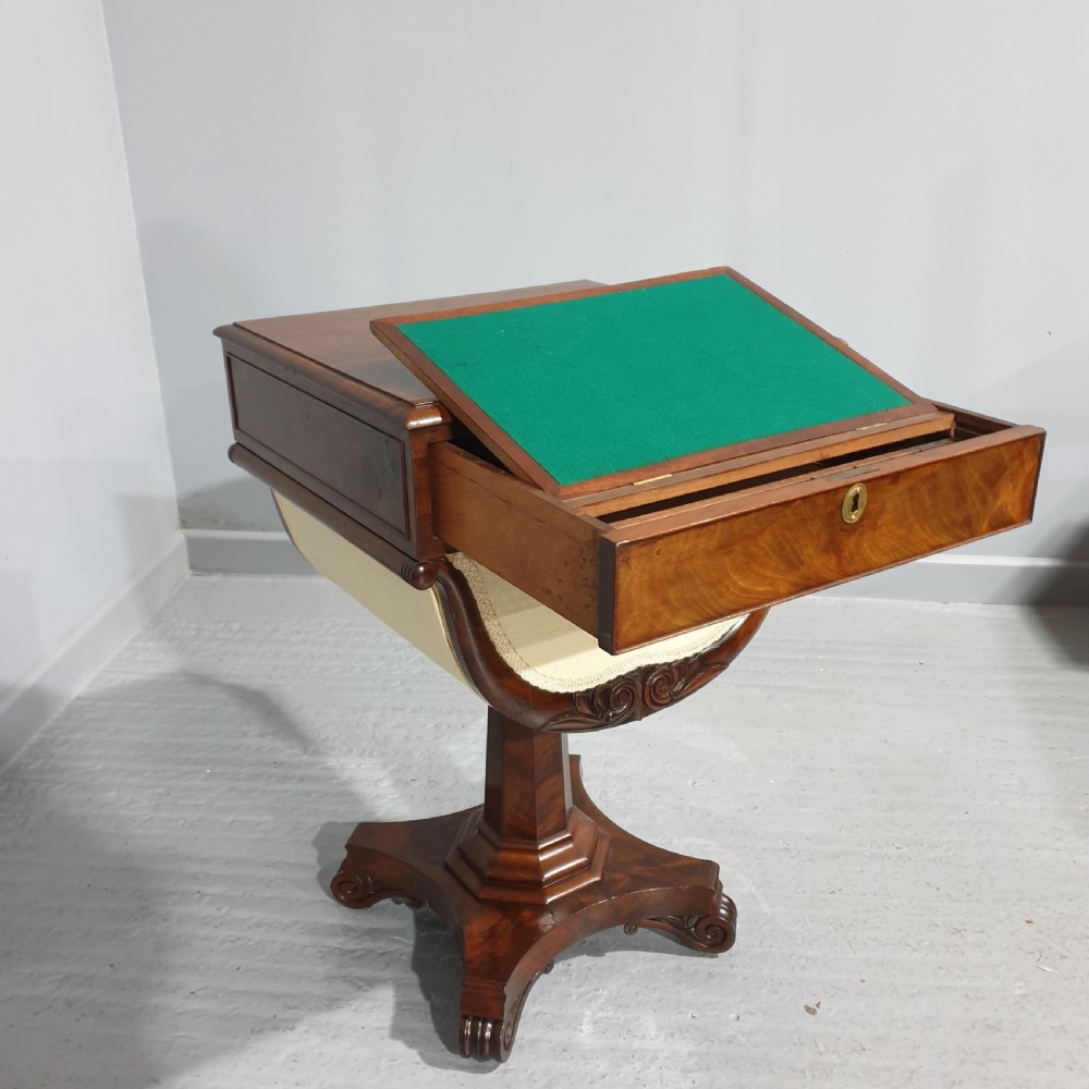 A William IV mahogany work box table featuring a single drawer over a cream fabric-lined storage well, supported on a central pedestal and quadform base with scroll feet. View VIII