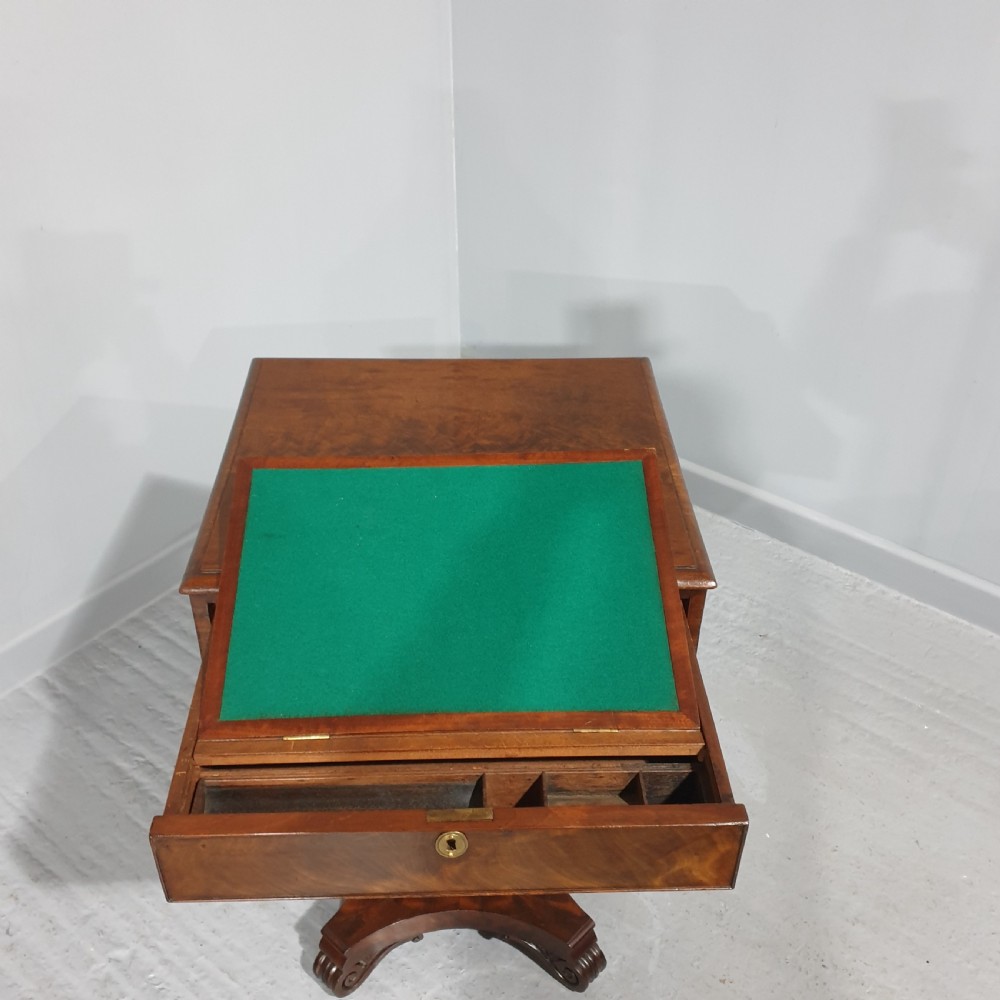 A William IV mahogany work box table featuring a single drawer over a cream fabric-lined storage well, supported on a central pedestal and quadform base with scroll feet. View VII