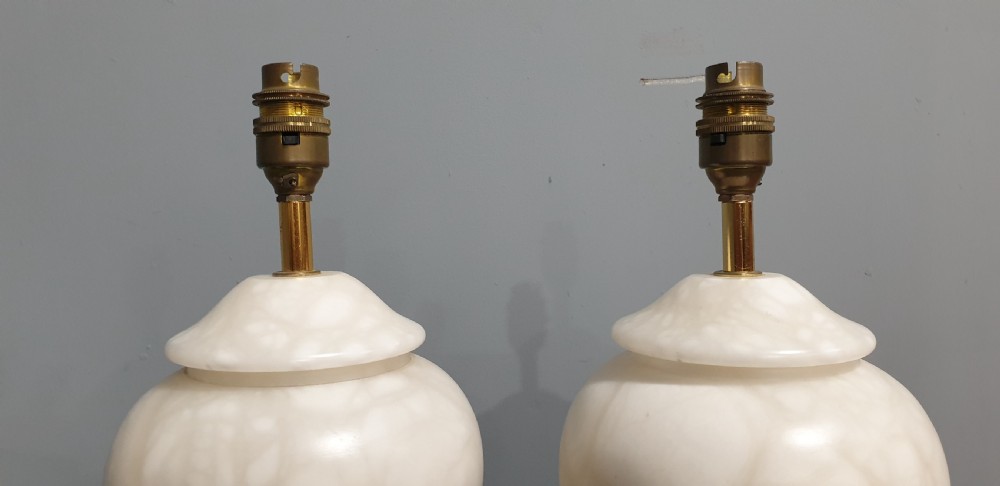 A pair of urn-shaped cream alabaster table lamps with variegated grey marble bases and brass fittings. View II