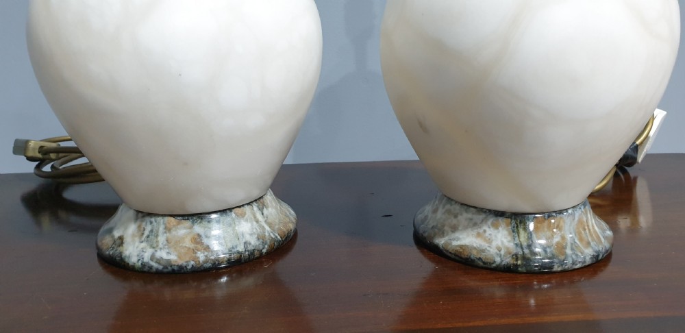 A pair of urn-shaped cream alabaster table lamps with variegated grey marble bases and brass fittings. View IV
