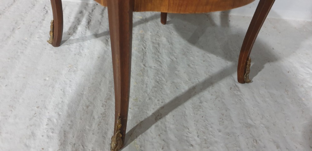A French Louis XV style occasional table with floral marquetry inlay, slender cabriole legs, a lower tier, and gilt bronze mounts. View V