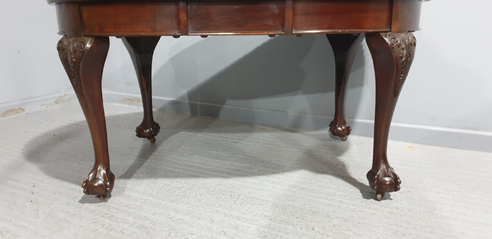 An oval Victorian mahogany extending dining table with carved cabriole legs terminating in ball and claw feet. View VII