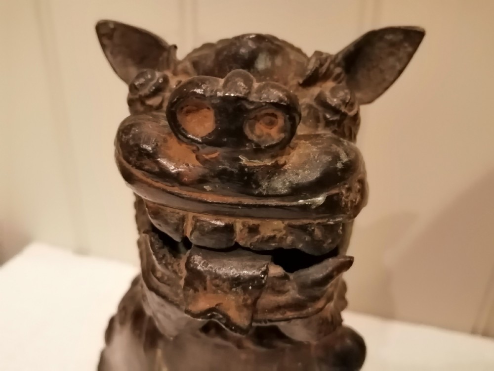An 18th-century dark patinated hollow bronze Japanese foo dog sculpture seated on its hind legs with one paw resting on a sphere. View XI