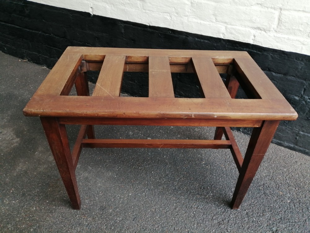 An Edwardian mahogany luggage rack featuring a slatted timber top, four square tapered legs, and lower side stretchers.