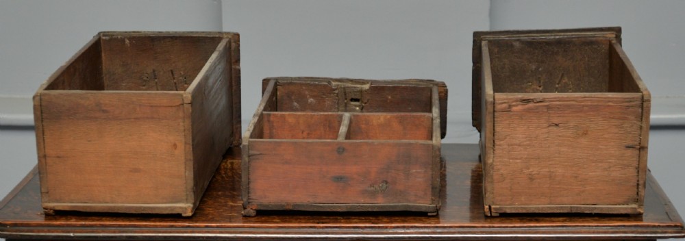 An early eighteenth-century oak lowboy featuring three drawers with brass handles, a scalloped apron, and four cabriole legs with pad feet. View XVII