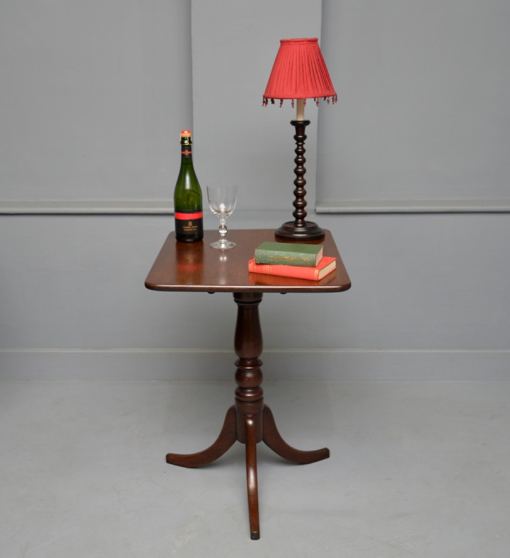 A Victorian solid mahogany wine table with a rectangular rounded top, a central turned pedestal, and a tripod base. View III