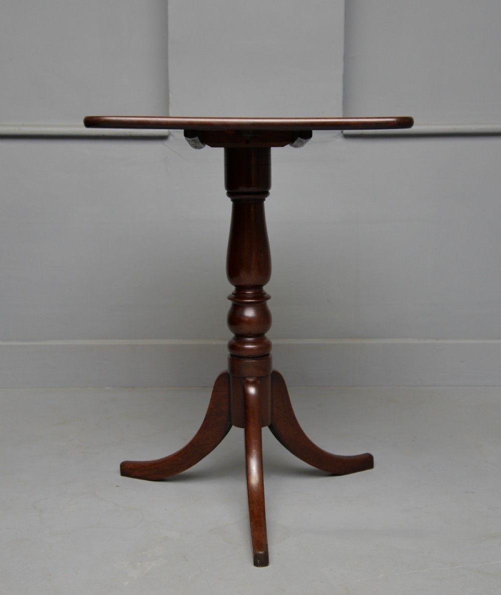 A Victorian solid mahogany wine table with a rectangular rounded top, a central turned pedestal, and a tripod base. View IX
