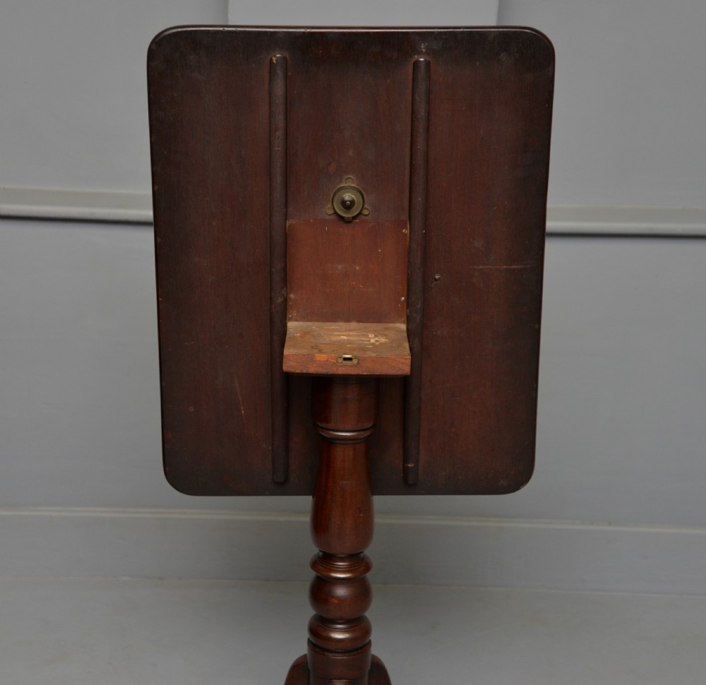 A Victorian solid mahogany wine table with a rectangular rounded top, a central turned pedestal, and a tripod base. View XIII