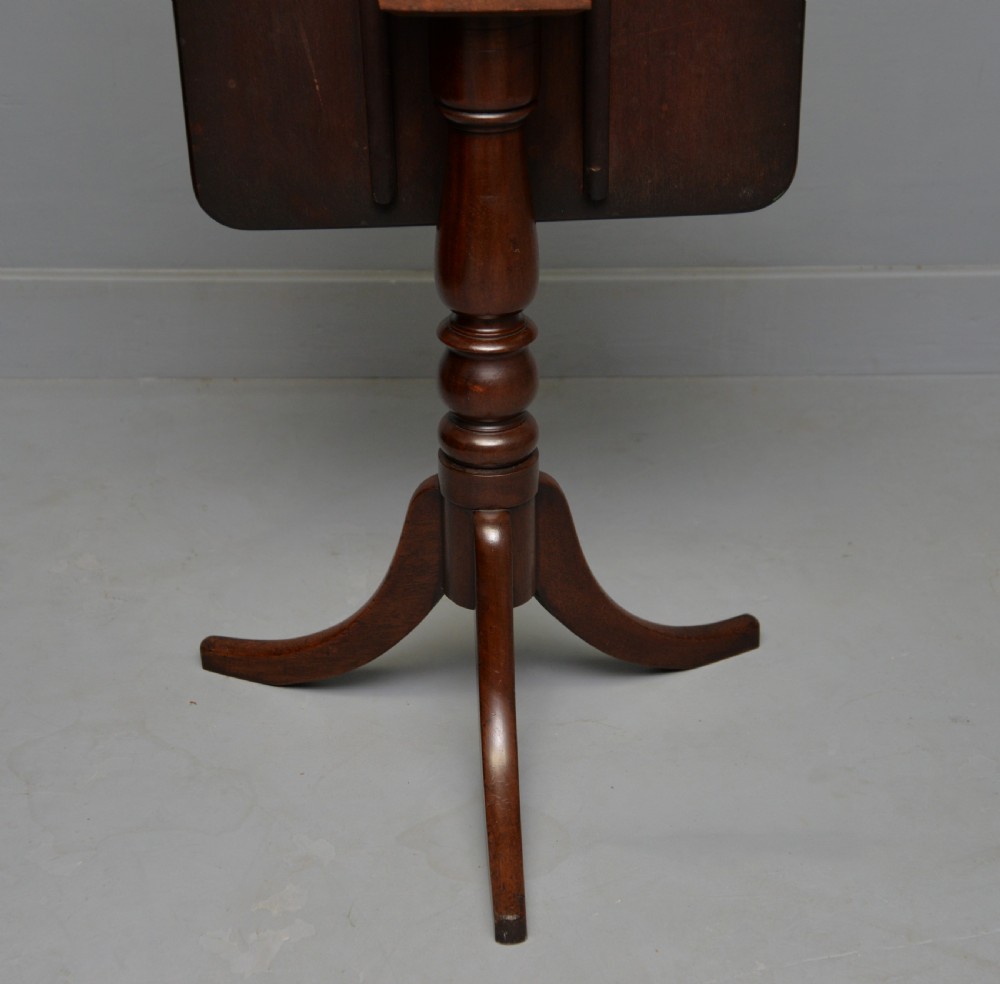 A Victorian solid mahogany wine table with a rectangular rounded top, a central turned pedestal, and a tripod base. View XIV