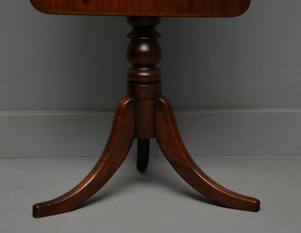A Victorian solid mahogany wine table with a rectangular rounded top, a central turned pedestal, and a tripod base. View XVI