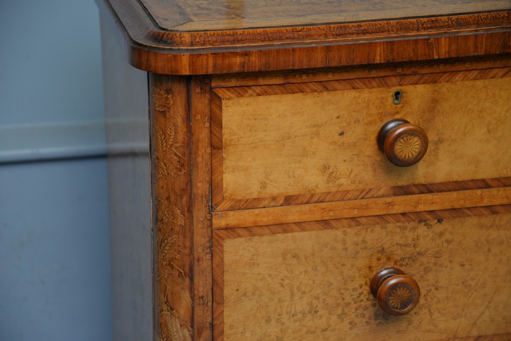A Victorian satinwood chest of drawers featuring two small upper drawers above three full-width drawers with turned rosette knobs and a plinth base. View VIII