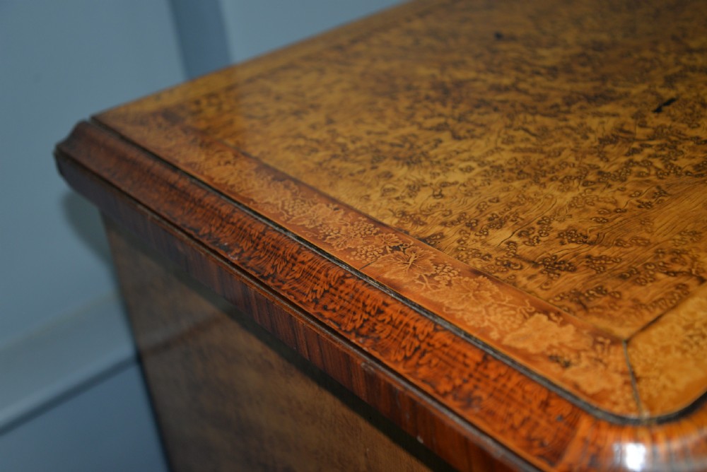 A Victorian satinwood chest of drawers featuring two small upper drawers above three full-width drawers with turned rosette knobs and a plinth base. View XI