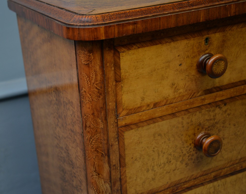 A Victorian satinwood chest of drawers featuring two small upper drawers above three full-width drawers with turned rosette knobs and a plinth base. View XXIV