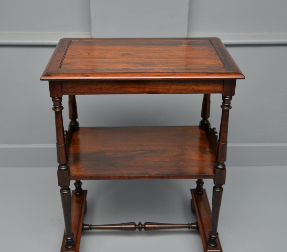 A dark William IV rosewood plant stand with a recessed upper tray, turned support posts, a lower shelf with carved scrollwork, and scroll feet. View IX