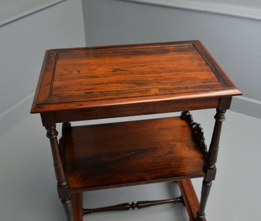 A dark William IV rosewood plant stand with a recessed upper tray, turned support posts, a lower shelf with carved scrollwork, and scroll feet. View XXII