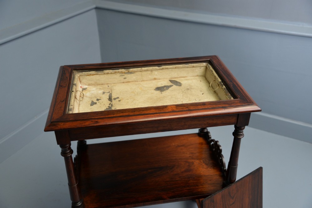 A dark William IV rosewood plant stand with a recessed upper tray, turned support posts, a lower shelf with carved scrollwork, and scroll feet. View XXIII
