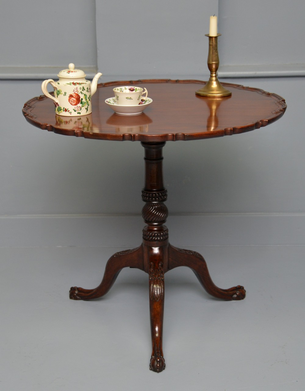 An 18th-century George III mahogany tripod table featuring a circular pie-crust rim, carved turned column, and cabriole legs ending in claw and ball feet. View II