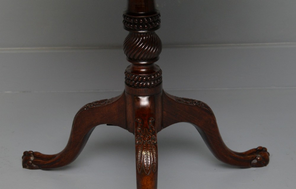 An 18th-century George III mahogany tripod table featuring a circular pie-crust rim, carved turned column, and cabriole legs ending in claw and ball feet. View VII