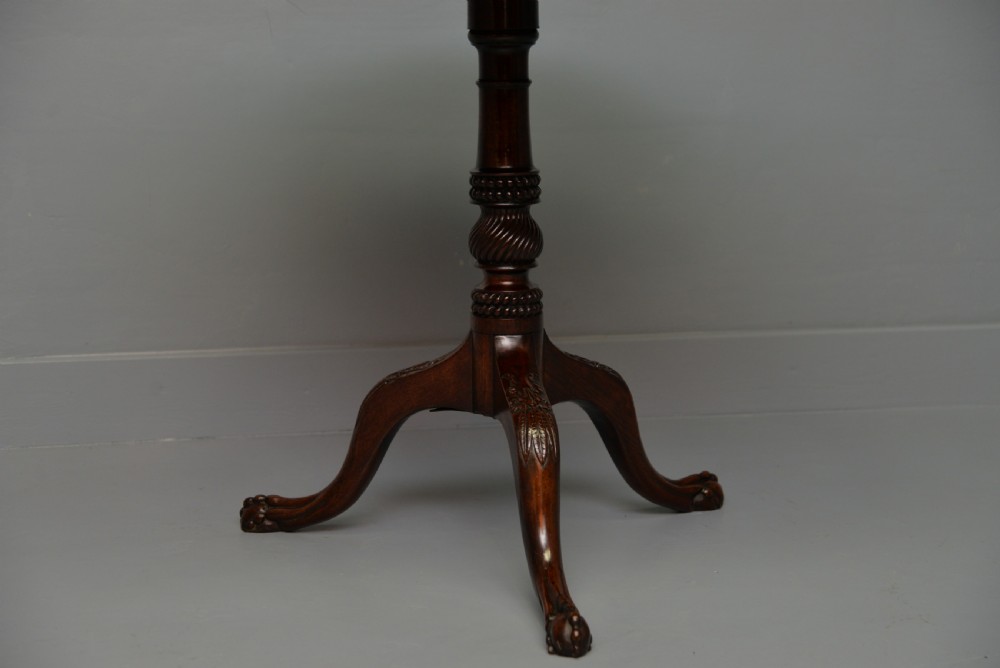 An 18th-century George III mahogany tripod table featuring a circular pie-crust rim, carved turned column, and cabriole legs ending in claw and ball feet. View IX