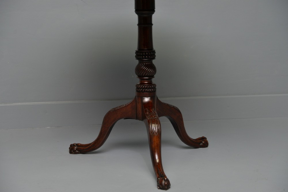An 18th-century George III mahogany tripod table featuring a circular pie-crust rim, carved turned column, and cabriole legs ending in claw and ball feet. View X