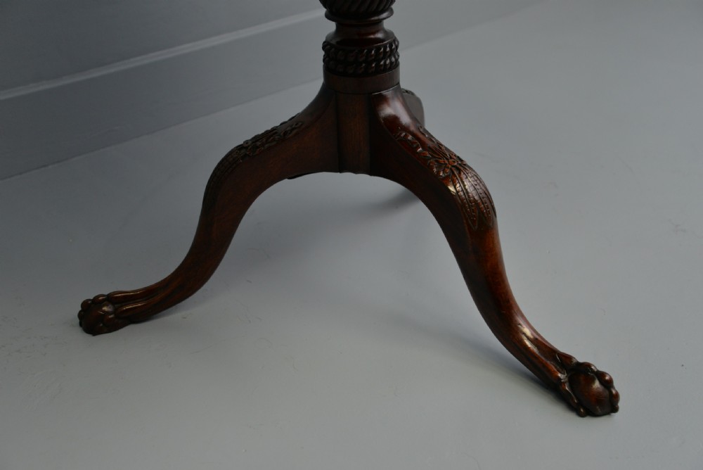 An 18th-century George III mahogany tripod table featuring a circular pie-crust rim, carved turned column, and cabriole legs ending in claw and ball feet. View XIII