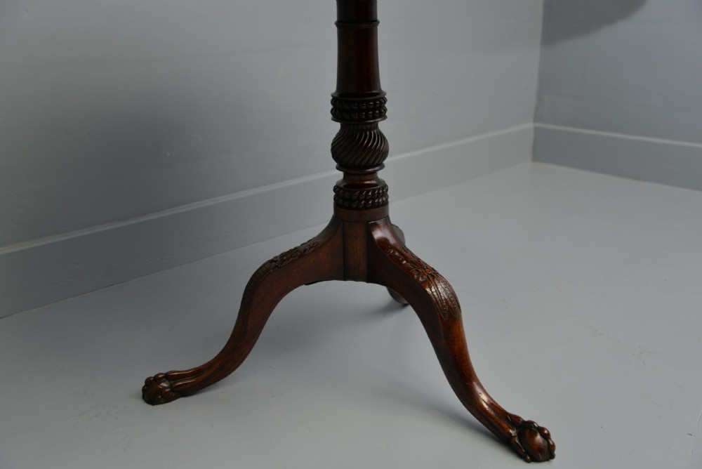 An 18th-century George III mahogany tripod table featuring a circular pie-crust rim, carved turned column, and cabriole legs ending in claw and ball feet. View XV