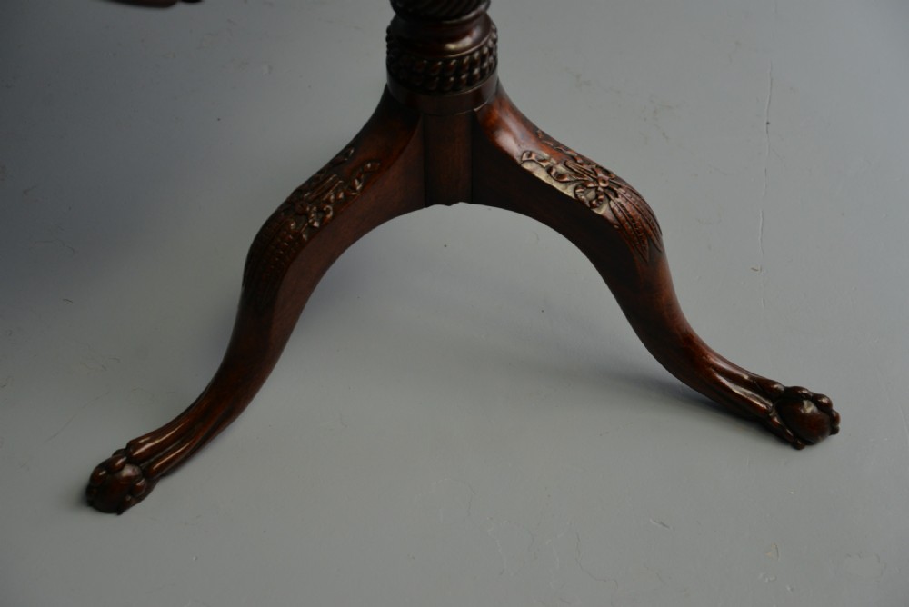 An 18th-century George III mahogany tripod table featuring a circular pie-crust rim, carved turned column, and cabriole legs ending in claw and ball feet. View XXII