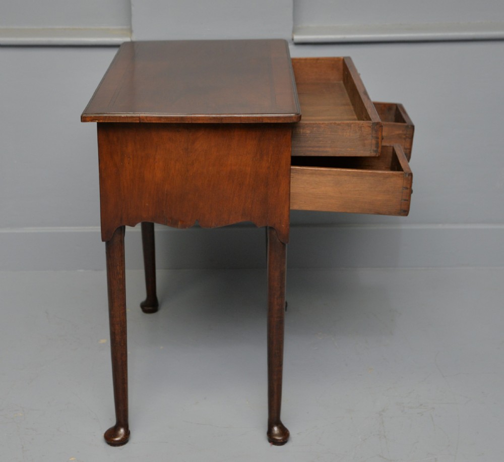 A George II revival walnut lowboy side table featuring three drawers with brass drop handles, a shaped kneehole apron, and slender cabriole legs with pad feet. View IX