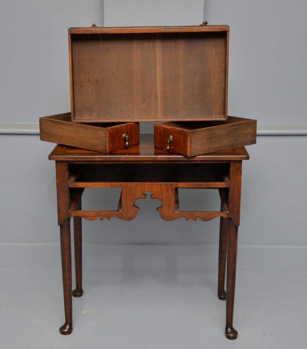 A George II revival walnut lowboy side table featuring three drawers with brass drop handles, a shaped kneehole apron, and slender cabriole legs with pad feet. View XII