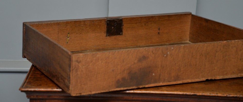 A 17th-century oak chest of drawers featuring geometric panel mouldings across four drawer fronts and brass drop handles. View XIV