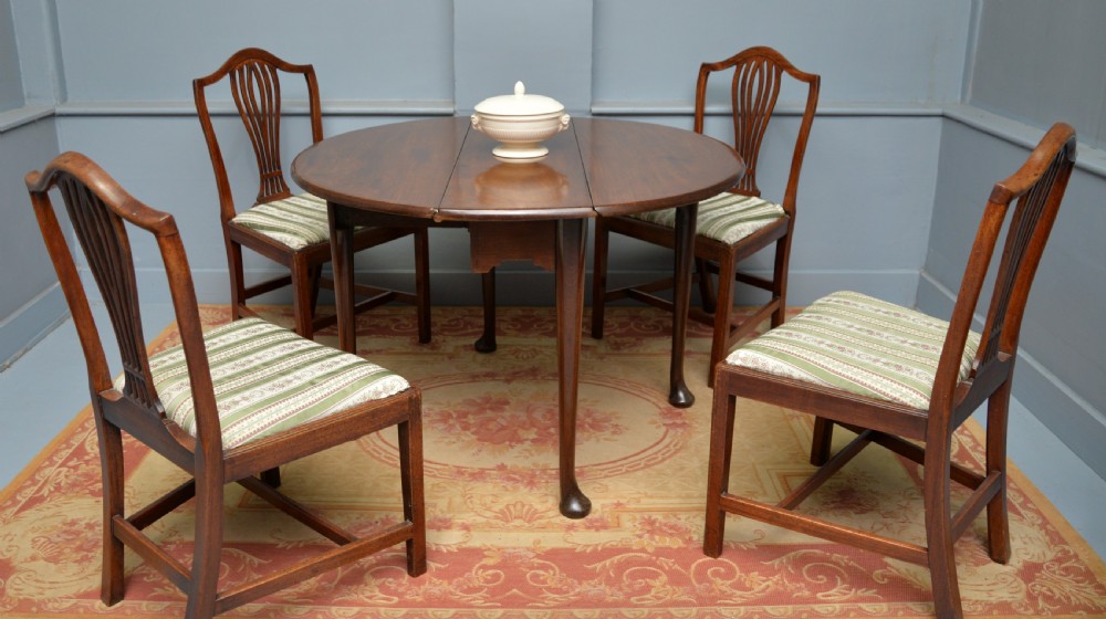 A George II mahogany drop-leaf dining table supported by slender tapered legs ending in pad feet. View III