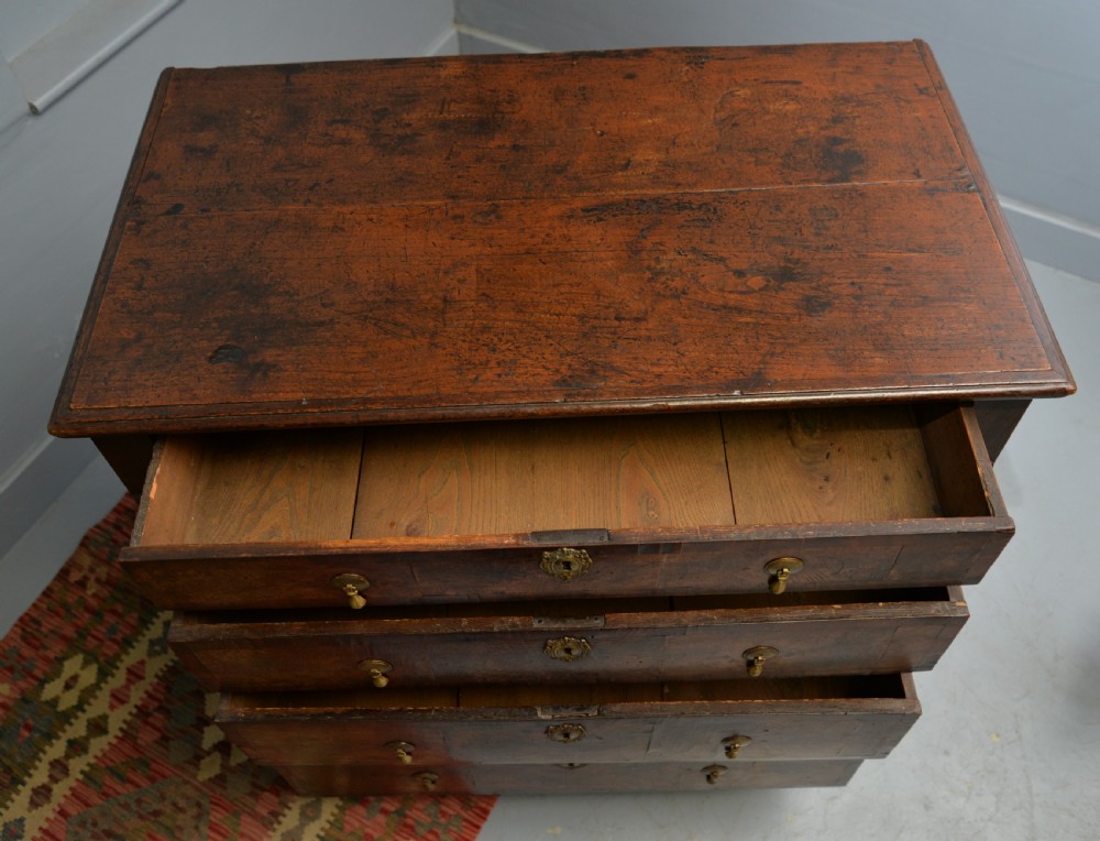 A William and Mary walnut and yew wood chest of four drawers featuring brass teardrop handles and decorative bead moulding. View XVI