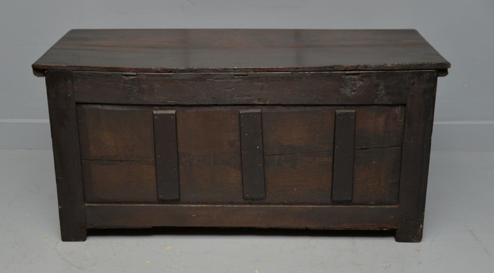 A 17th-century dark oak coffer featuring three carved arcaded front panels with diamond marquetry inlays and detailed frieze carving. View XI