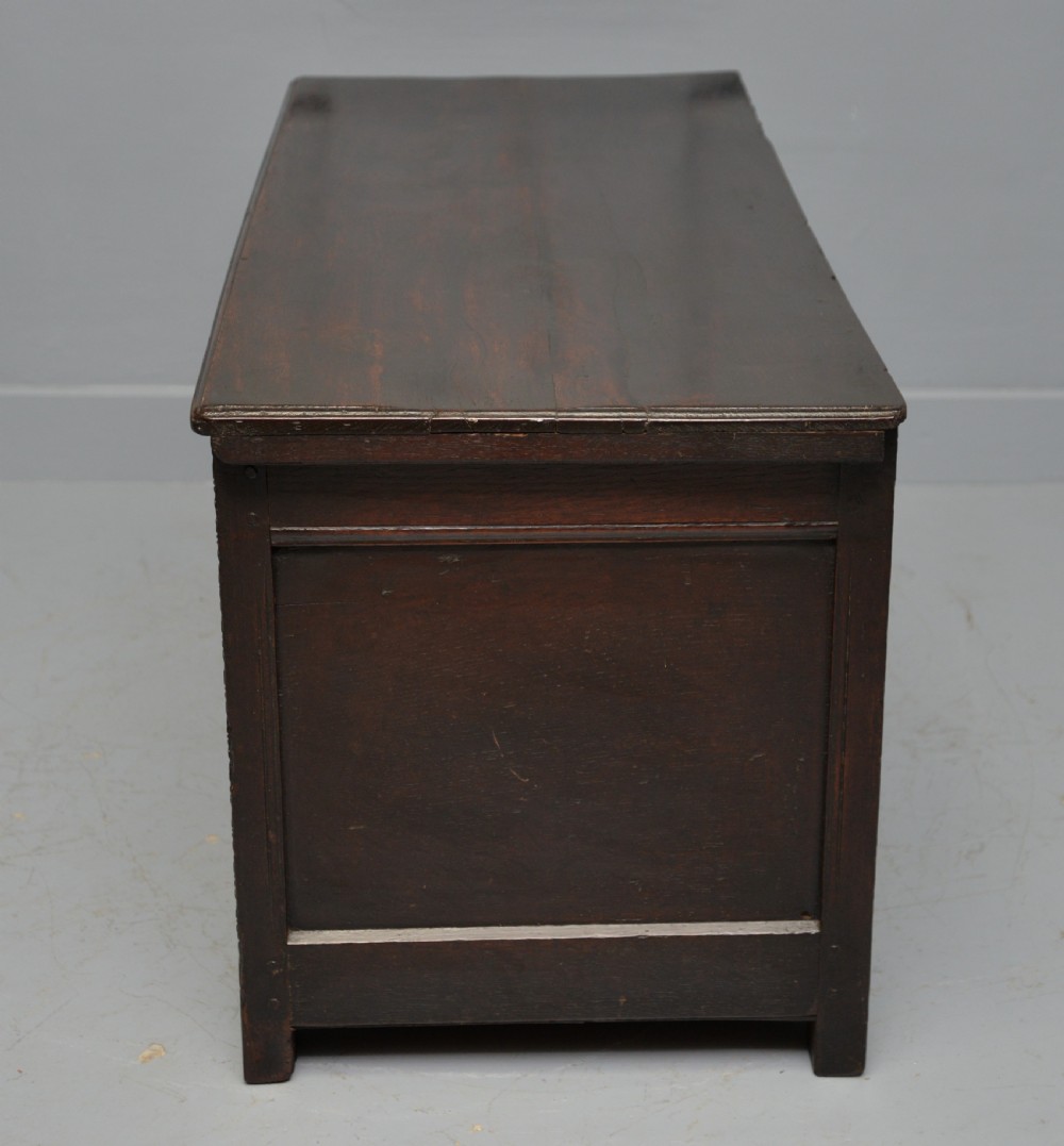 A 17th-century dark oak coffer featuring three carved arcaded front panels with diamond marquetry inlays and detailed frieze carving. View XII
