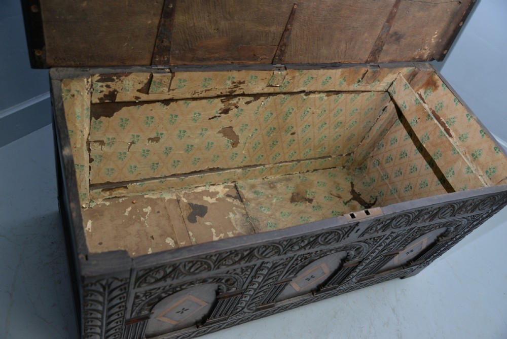 A 17th-century dark oak coffer featuring three carved arcaded front panels with diamond marquetry inlays and detailed frieze carving. View XIV