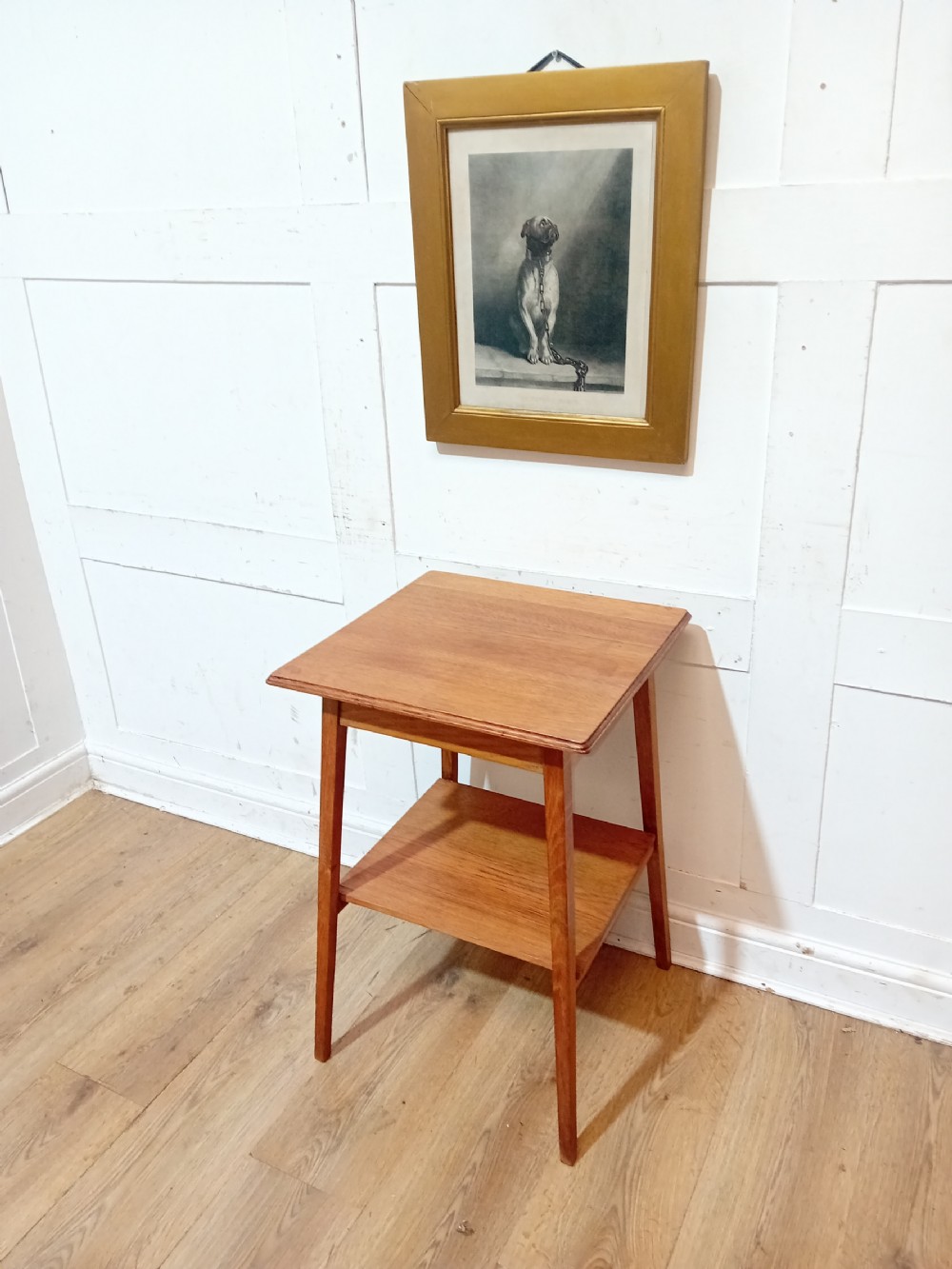 A square Arts and Crafts oak side table featuring an undertier shelf and straight tapered legs.