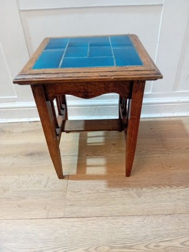 An Arts and Crafts style oak side table featuring a square top inset with vibrant blue ceramic tiles, straight tapered legs, and a lower stretcher shelf. View XII