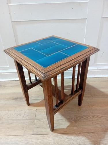 An Arts and Crafts style oak side table featuring a square top inset with vibrant blue ceramic tiles, straight tapered legs, and a lower stretcher shelf. View IX