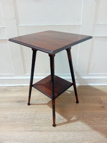 An antique dark wood Arts and Crafts side table featuring turned legs, a square top, and a lower tier shelf. View V
