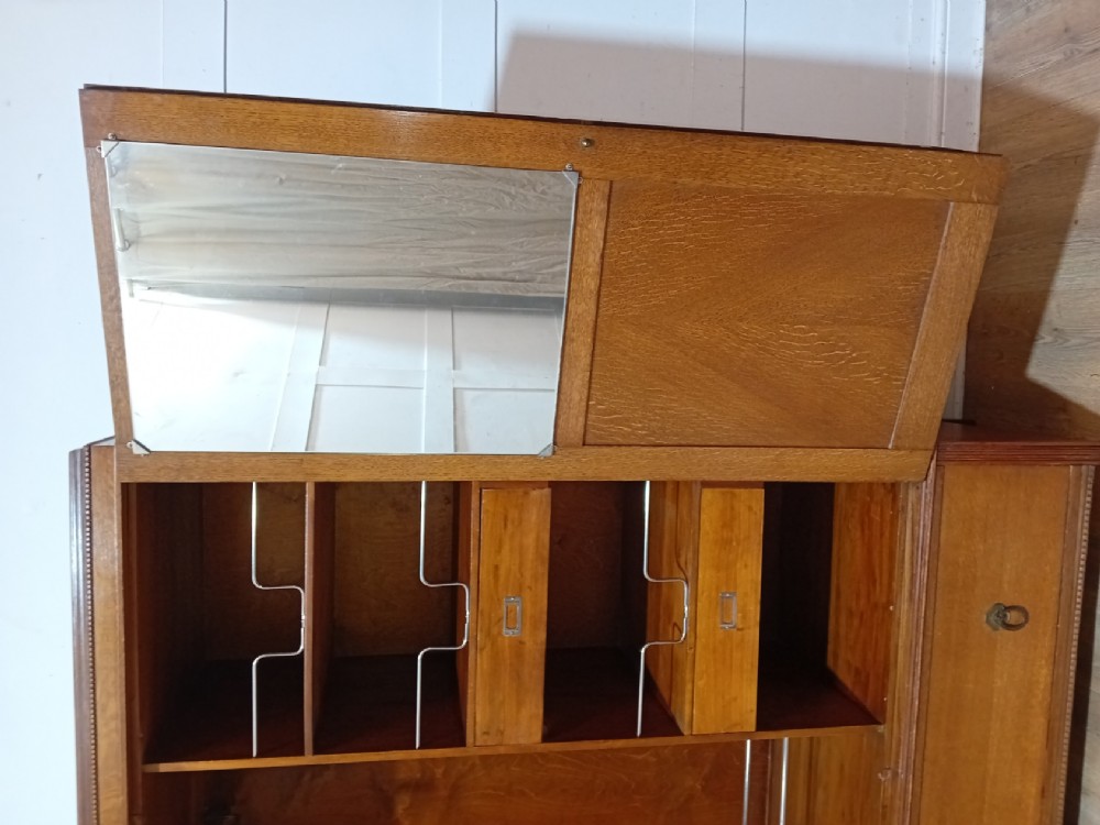 An Edwardian oak compactum wardrobe featuring two panelled doors with chevron oak veneers above a wide single drawer with brass drop handles. View XIII