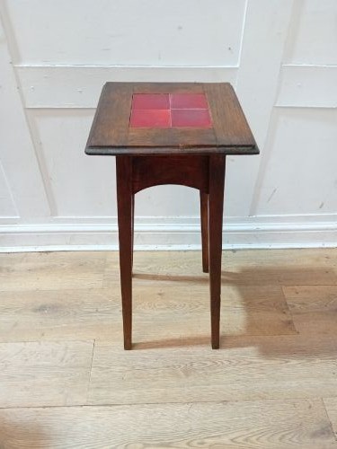A tall Arts and Crafts dark oak jardiniere stand featuring four red ceramic tiles inset on the top surface and slim tapered legs. View VII